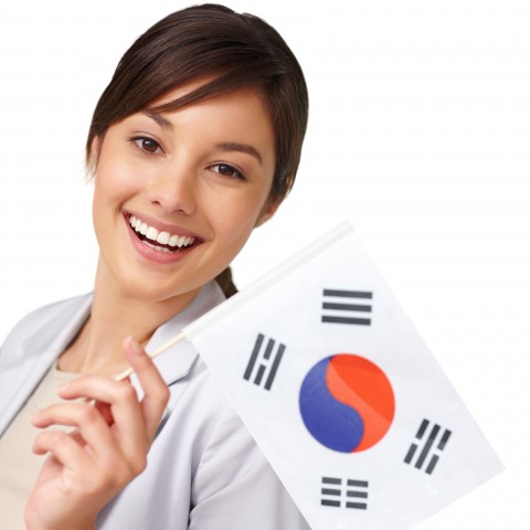 A Woman Smiling with a Korean Flag in Her Hand