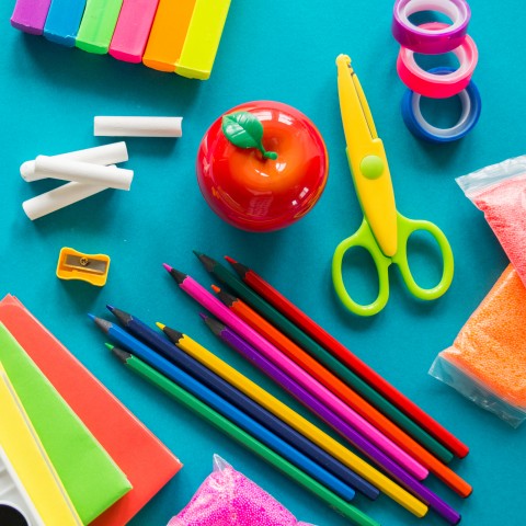 School Supplies for Junior Class; Color Pencils, Scissors, White Chalk, an Apple Pencil Sharpener, Clay.