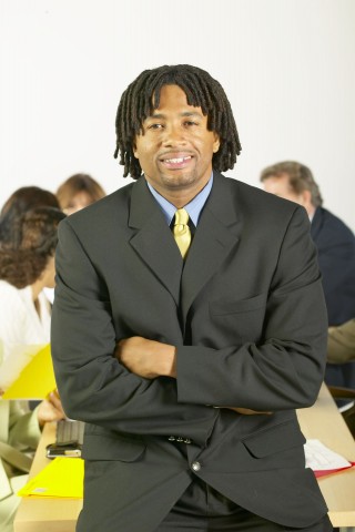 A Man in a Business Suit Crossing His Arms