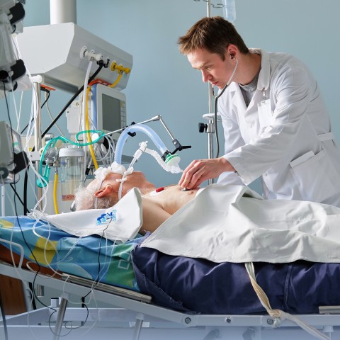 A Doctor Listens to a Patient’s Heart in a Hospital.