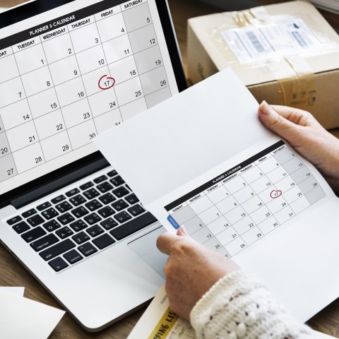 Hands Holding Planner and Calendar, Computer with Calendar