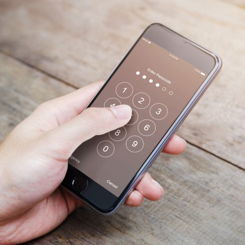 Someone Punching a Passcode into Their Cellphone