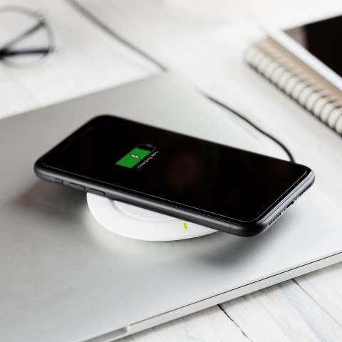 A phone charging on a dock