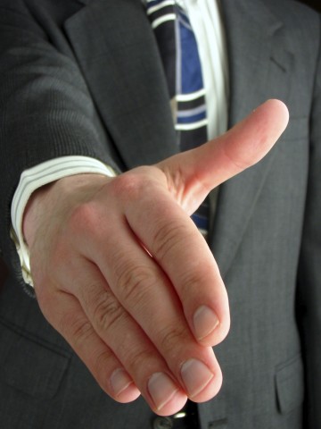 A Business Professional Extending His Hand to Shake