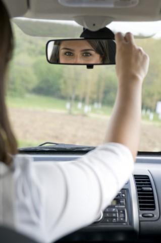 Woman Looking in the Rear-view Mirror