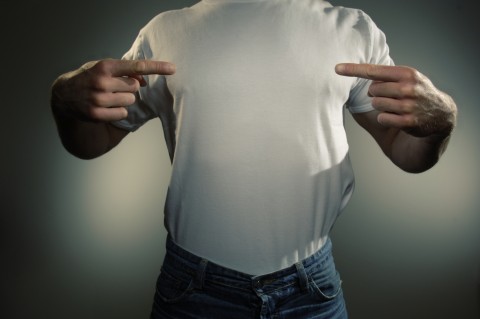 Man in White T-shirt Pointing to His Torso