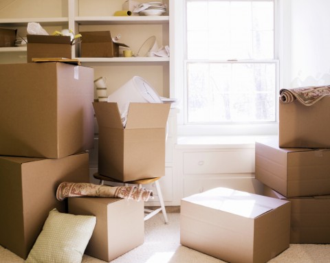 Cardboard boxes stacked inside a home during a move