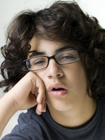 Bored-looking Teenage Boy with Glasses
