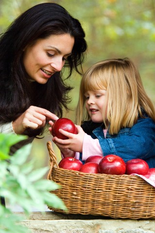 Daughter Giving an Apple to Her Mother