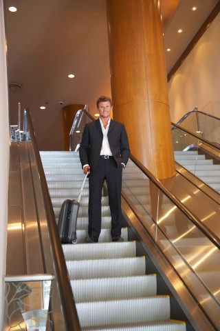 Man Standing on the Escalator