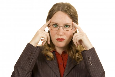 A Woman Pointing to Her Head with Both Hands