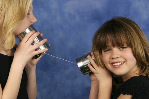 Two Kids Talking through Tin Can Phone