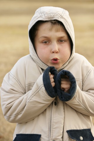 A Young Boy Wearing a Winter Hoodie in Cold Weather