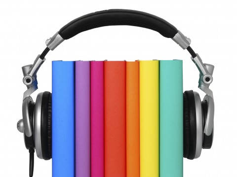 Headphones with Colorful Books Stacked Upright between Them