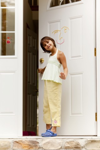 A Girl Standing at an Open Door