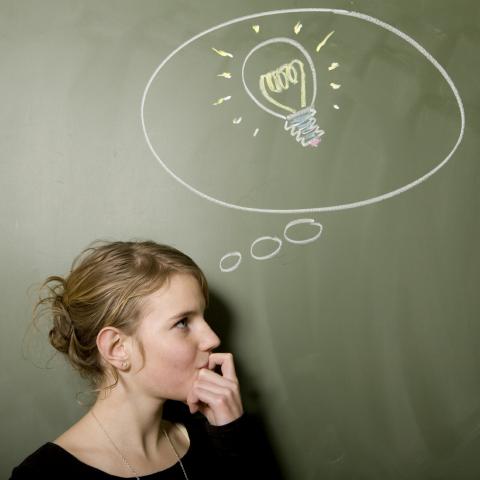 Woman with Chalk Drawing of Light Bulb Above head