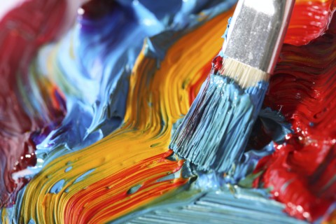 A Paint Brush and Different Colored Paints