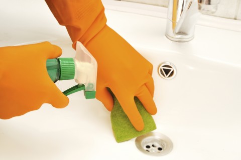 A Close-up of Hands Cleaning a Sink.