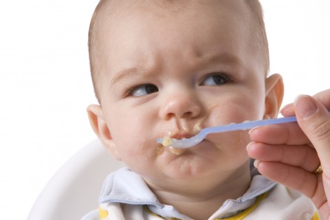 A Baby Being Fed Baby Food