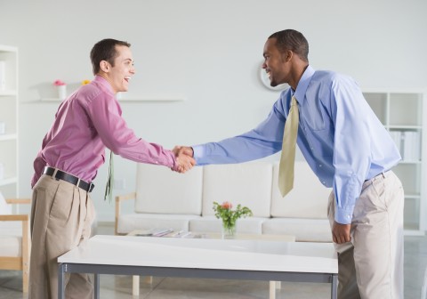 Two Men Shaking Hands at a Distance