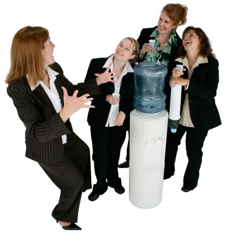 Women in Suits Talking Around a Water Cooler