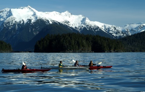 People Kayaking in Lake Near Mountains