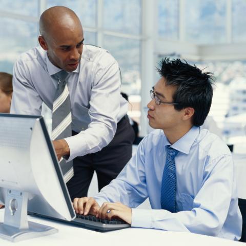 A Supervisor Helping an Employee with Something on Their Computer