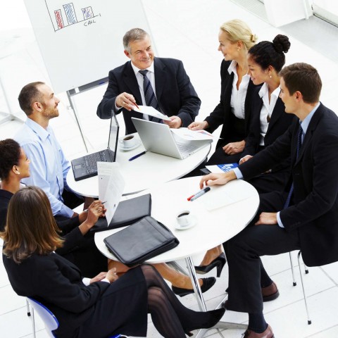 Business Associates Sitting at a Circular Table Together