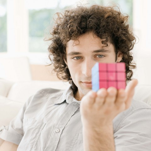 Man Holding Completed Rubik’s Cube