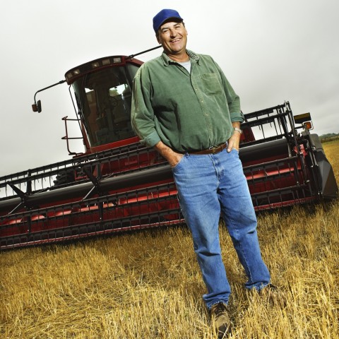 Farmer in Field in Front of Machine