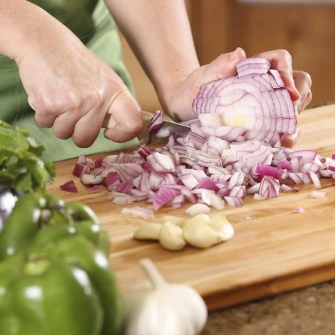 Woman Chopping a Red Onion