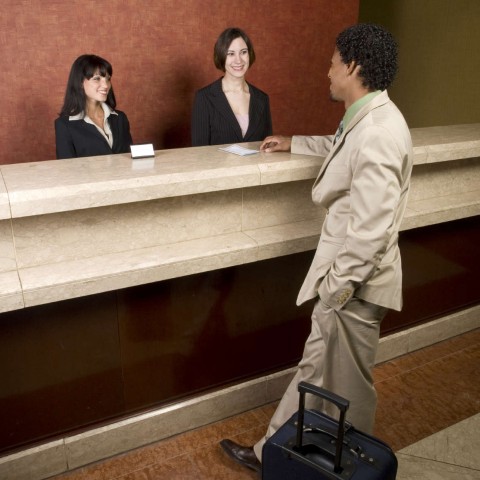 A Man Checking in at a Hotel