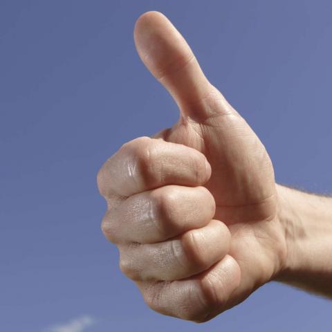 A Hand Showing a Thumb-up.