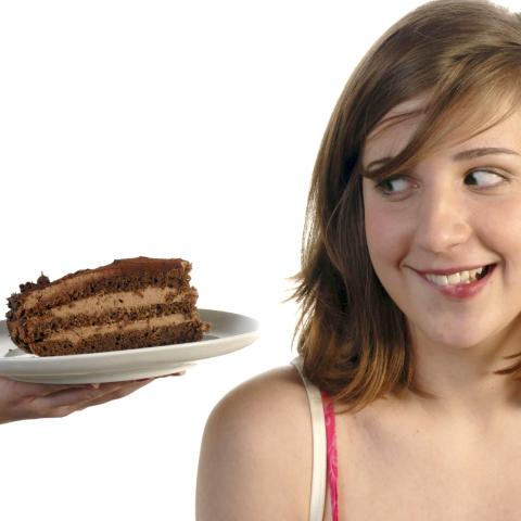 A Woman Staring at Chocolate Cake