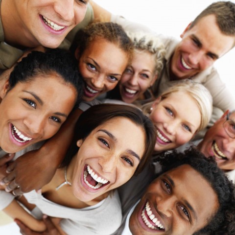 Nine People Hugging, Smiling and Looking at the Camera