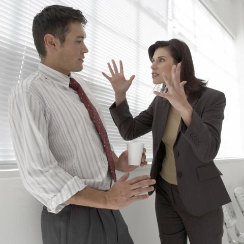 Woman Making Angry Gesture at Man