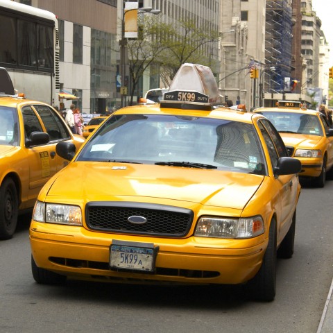 A Fleet of Yellow-cab Taxis on the Road