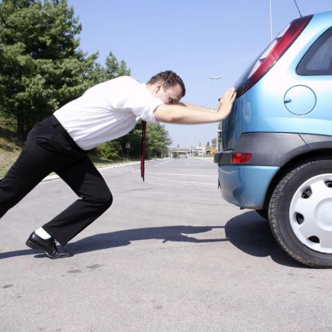 Car being Pushed by Man