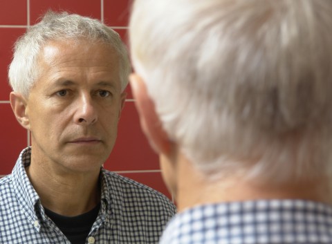 A Guy Looking at Himself in the Mirror