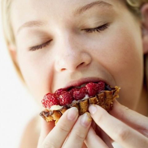 A Woman Biting into a Tart