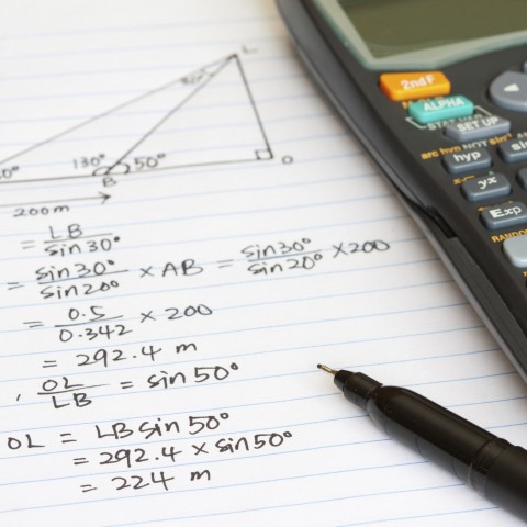 Geometry Homework on a Writing Pad, with a Pen and Scientific Calculator.