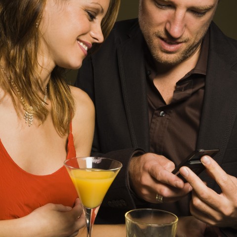 A Man in a Suit is Asking a Woman in a Red Dress for a Phone Number